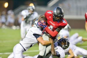 Mallik Griffin hangs onto the ball as he is brought down Friday by the Clover defense. (Photo/Ross Burton)
