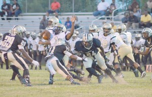Chad Sampson (11) puts the stop on Don Halley as Tony Ruff (29) and Marshawn Geiger (24) close in. (Photo/DeAnna Robinson)