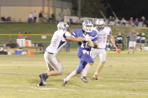RWA quarterback Gunnar Hensley feels the pressure of the Greenwood Christian defense. (Photo/Martha Ladd) 