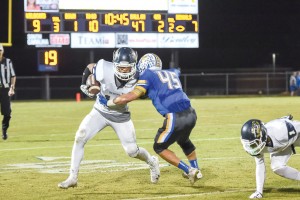 Jacob McGuire takes a David Isreal pass and fights for yards. (Photo/Kristy Kimball Massey)