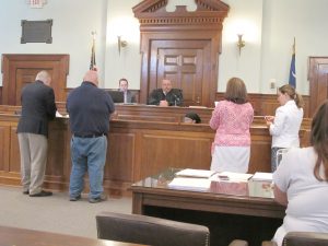 Billy Ray Huskey (second from left) and his defense attorney Robert Bruce stand before Judge Brian Gibbons Monday with Kathy Faulk of Hoof & Paw and prosecutor Melissa Heimbaugh. (Photo/Barbara Ball)