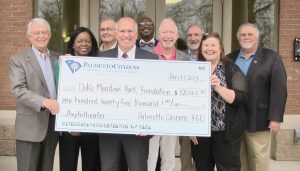 Nick Wodogaza, center, President of Blythewood’s newly opened Palmetto Citizens Federal Credit Union, presents a check for $125,000 for the naming rights to the Town’s new amphitheater to Jim McLean, left, Chairman of the Doko Meadows Park Foundation; Foundation members Martha Crawford and Buddy Price; Wodogaza; Town Councilmen Larry Griffin, Eddie Baughman and Malcolm Gordge; the Town’s financial assistant Chris Keefer and Mayor J. Michael Ross.  (Photo/Barbara Ball)